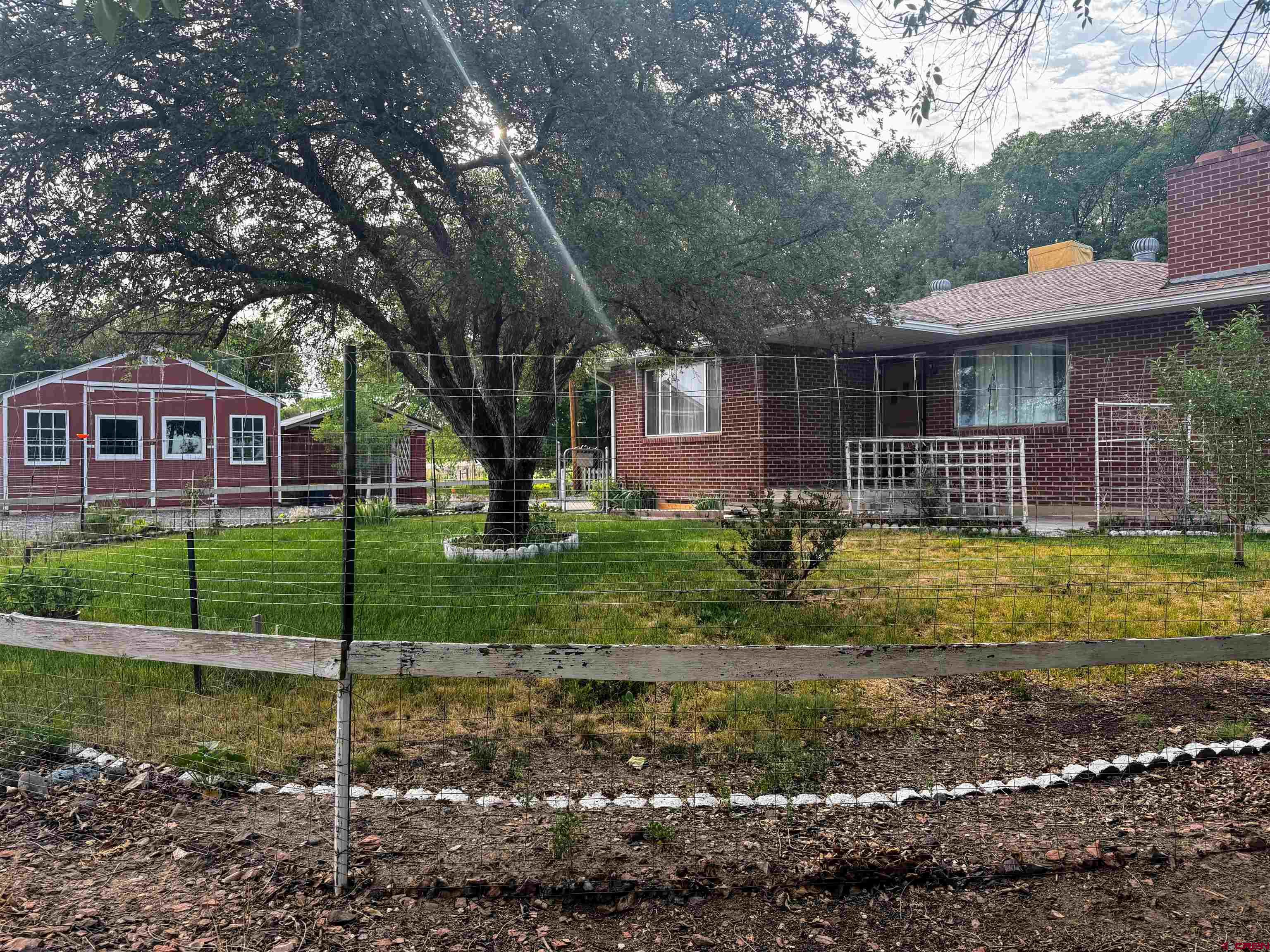20114 Austin Road Austin, CO 81410 - Photo 2 of 26 a front view of a house with a yard