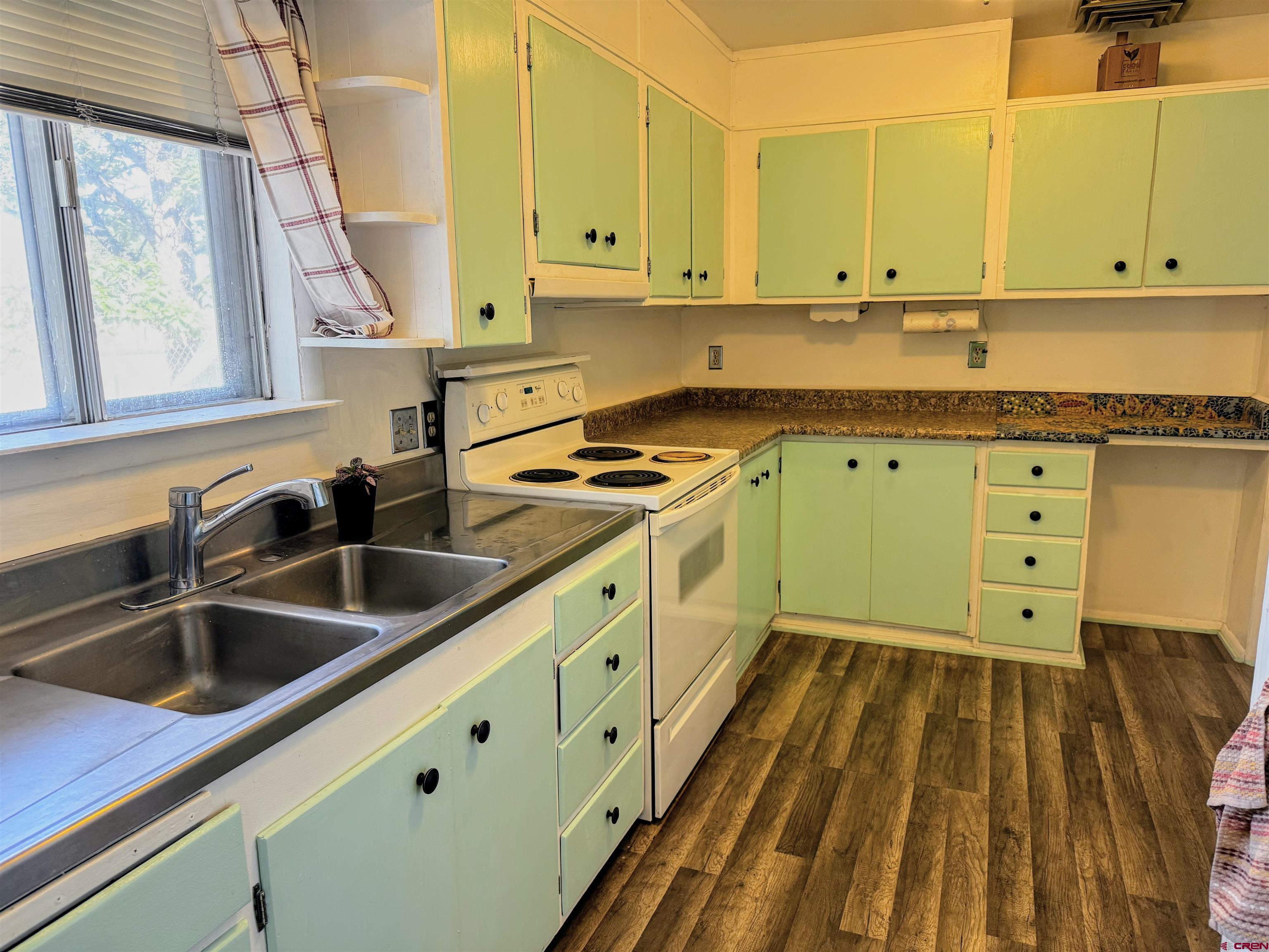 20114 Austin Road Austin, CO 81410 - Photo 10 of 26 a kitchen with sink cabinets and window