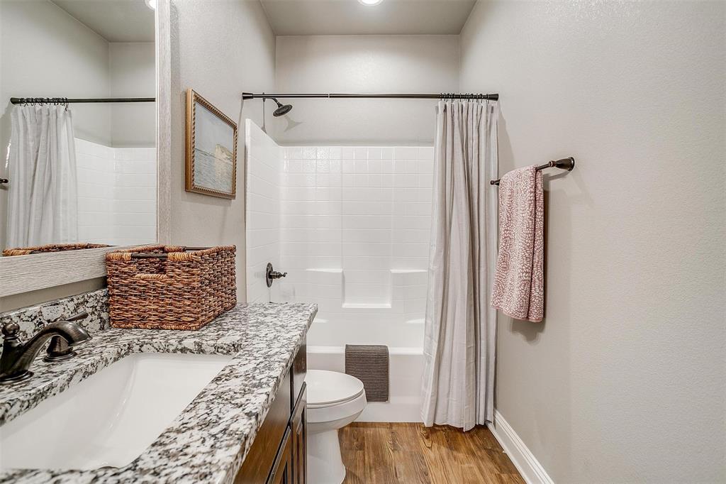 2708 James Road Granbury, TX 76049 - Photo 29 of 34 a bathroom with a granite countertop shower and a sink