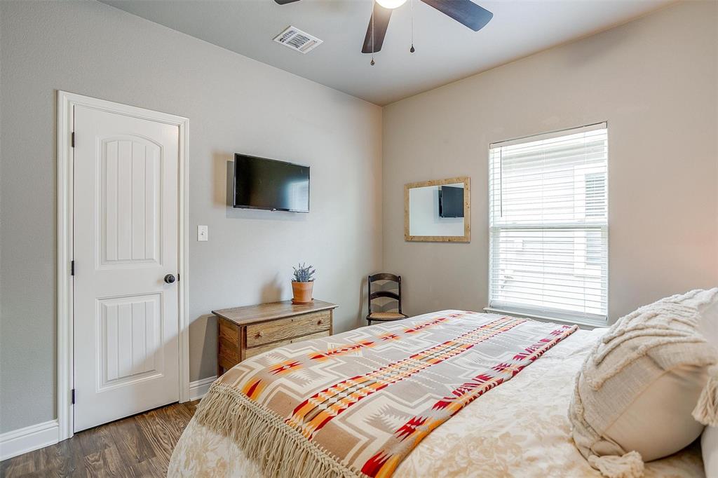 2708 James Road Granbury, TX 76049 - Photo 34 of 34 a bedroom with a bed and a flat screen tv