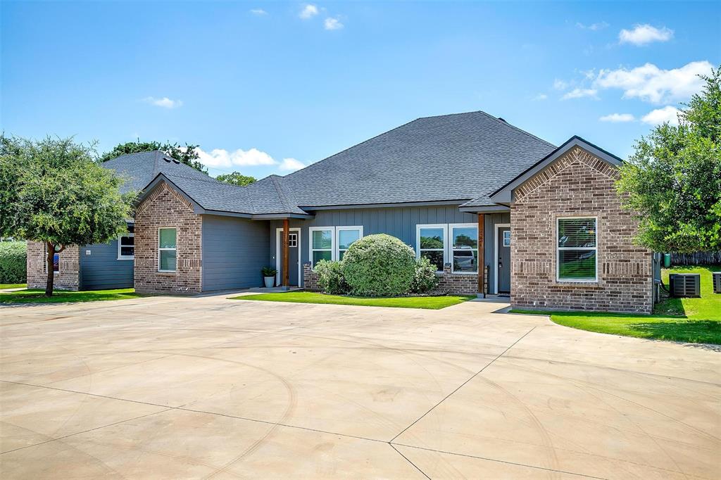 2708 James Road Granbury, TX 76049 - Photo 4 of 34 a front view of a house with a yard and potted plants