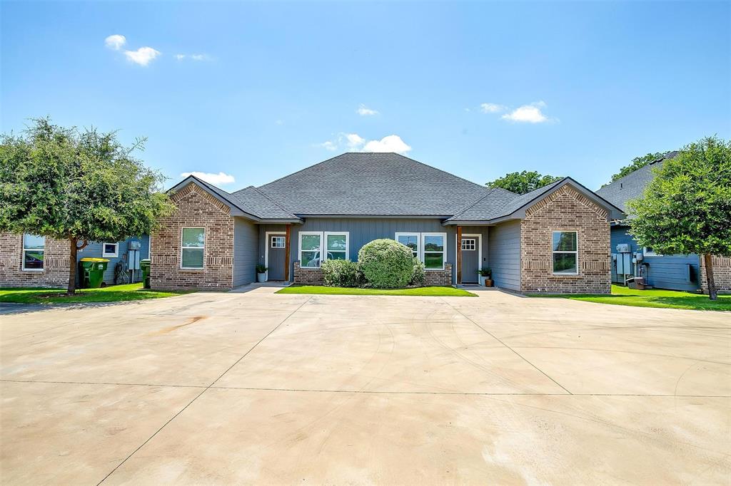 2708 James Road Granbury, TX 76049 - Photo 5 of 34 a front view of a house with a yard and garage