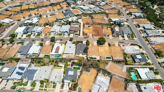 an aerial view of a house with a yard and lake view