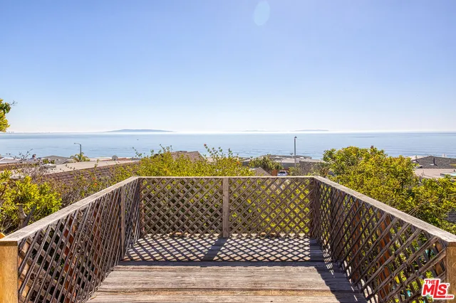 a view of balcony with wooden floor and city view