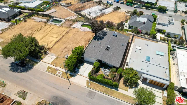 an aerial view of a house with a yard and sitting area