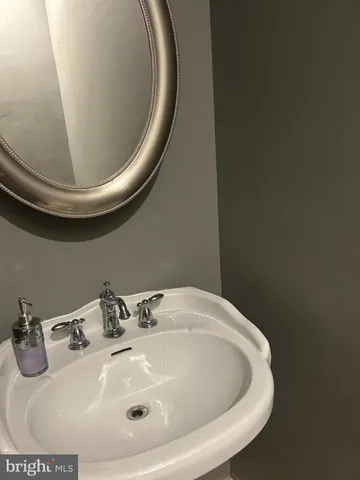 a bathroom with a sink and mirror