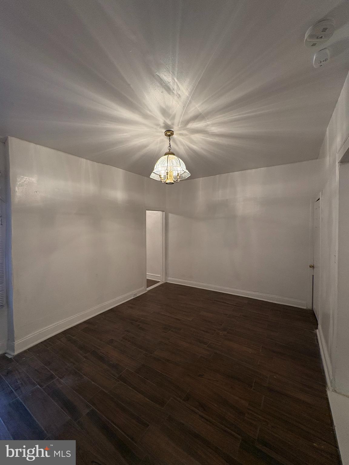 3219 North 29th Street Philadelphia, PA 19129 - Photo 3 of 17 a view of an empty room with wooden floor and a ceiling fan