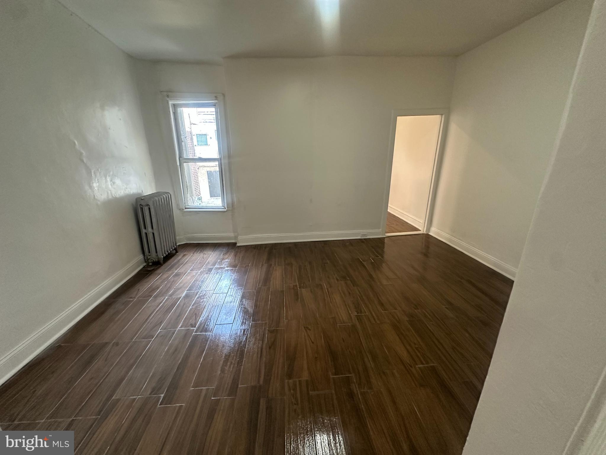 3219 North 29th Street Philadelphia, PA 19129 - Photo 7 of 17 an empty room with wooden floor and windows