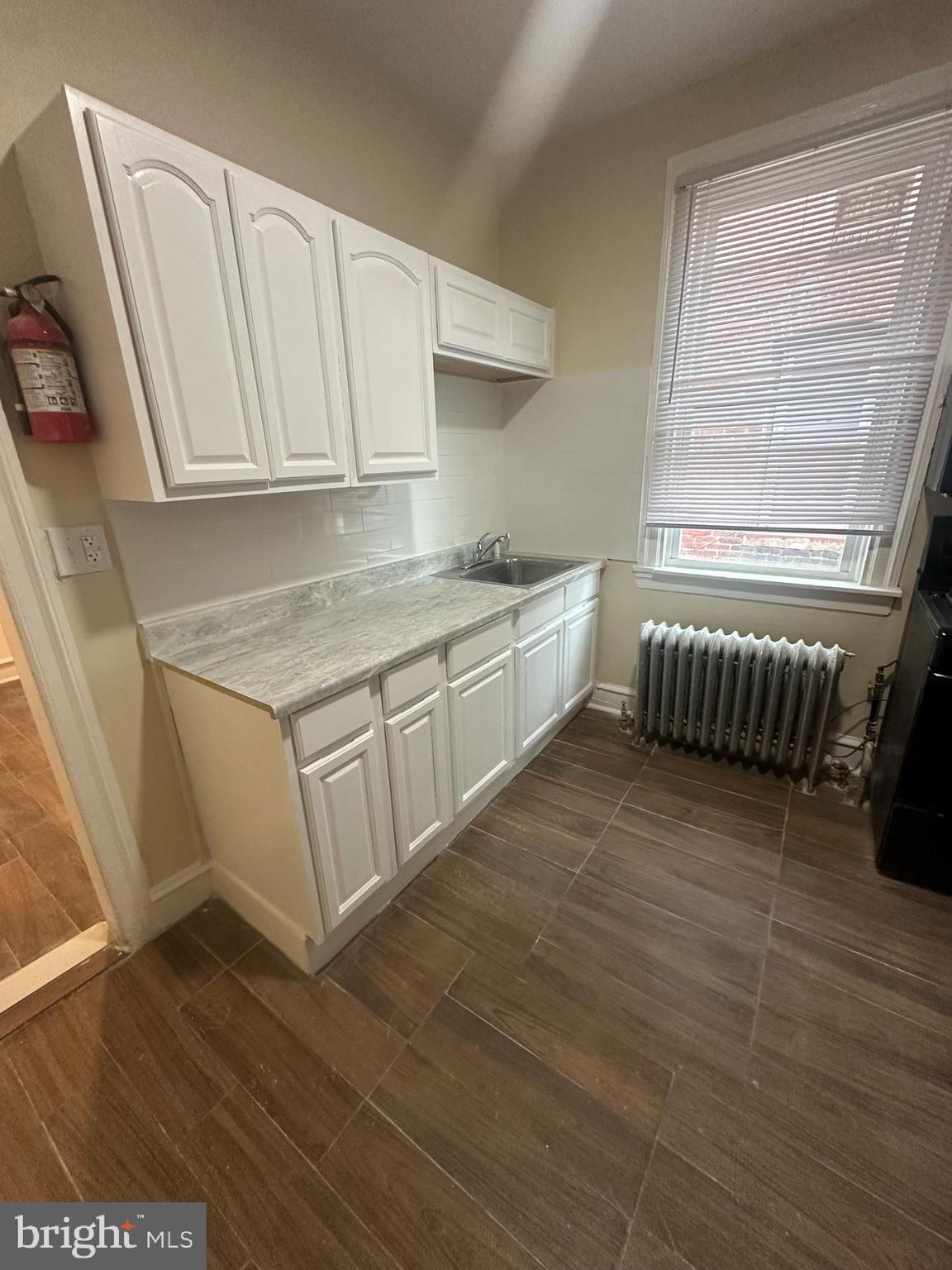 3219 North 29th Street Philadelphia, PA 19129 - Photo 9 of 17 a kitchen with granite countertop white cabinets and white appliances