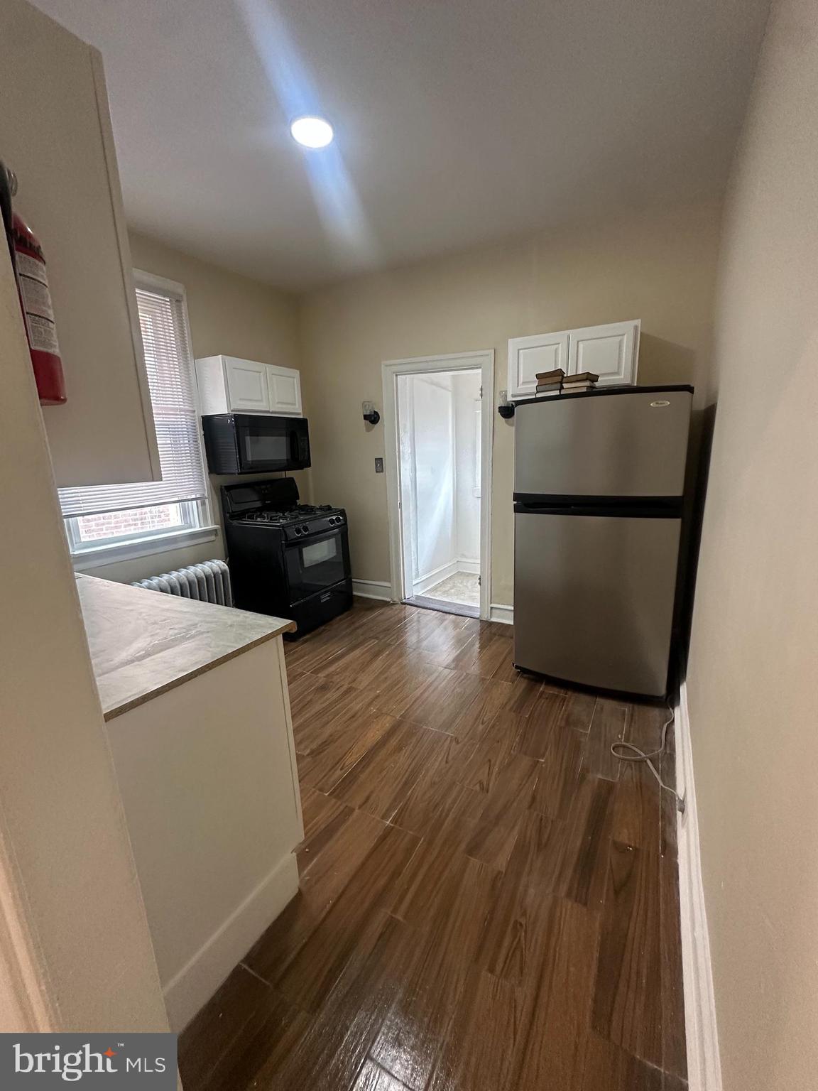 3219 North 29th Street Philadelphia, PA 19129 - Photo 10 of 17 a kitchen with a refrigerator and a stove