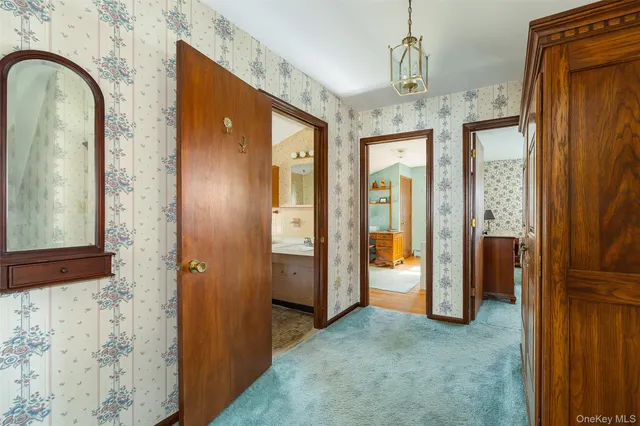 a view of an empty room with glass door and wooden floor