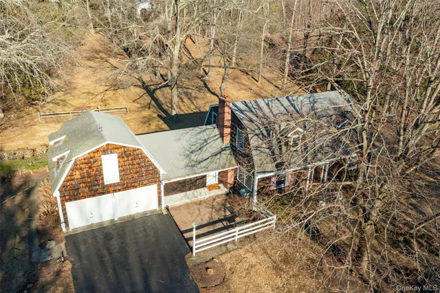 a view of a backyard with wooden fence and a bench