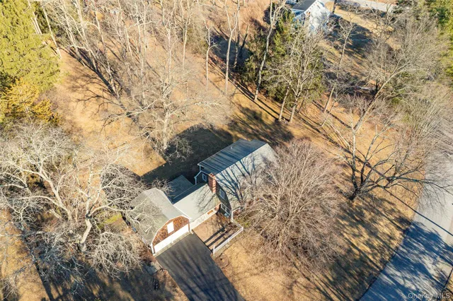 a front view of a house with a yard covered with snow