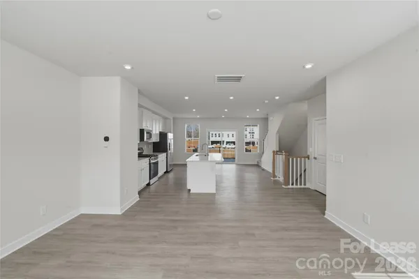 a view of kitchen with furniture and wooden floor