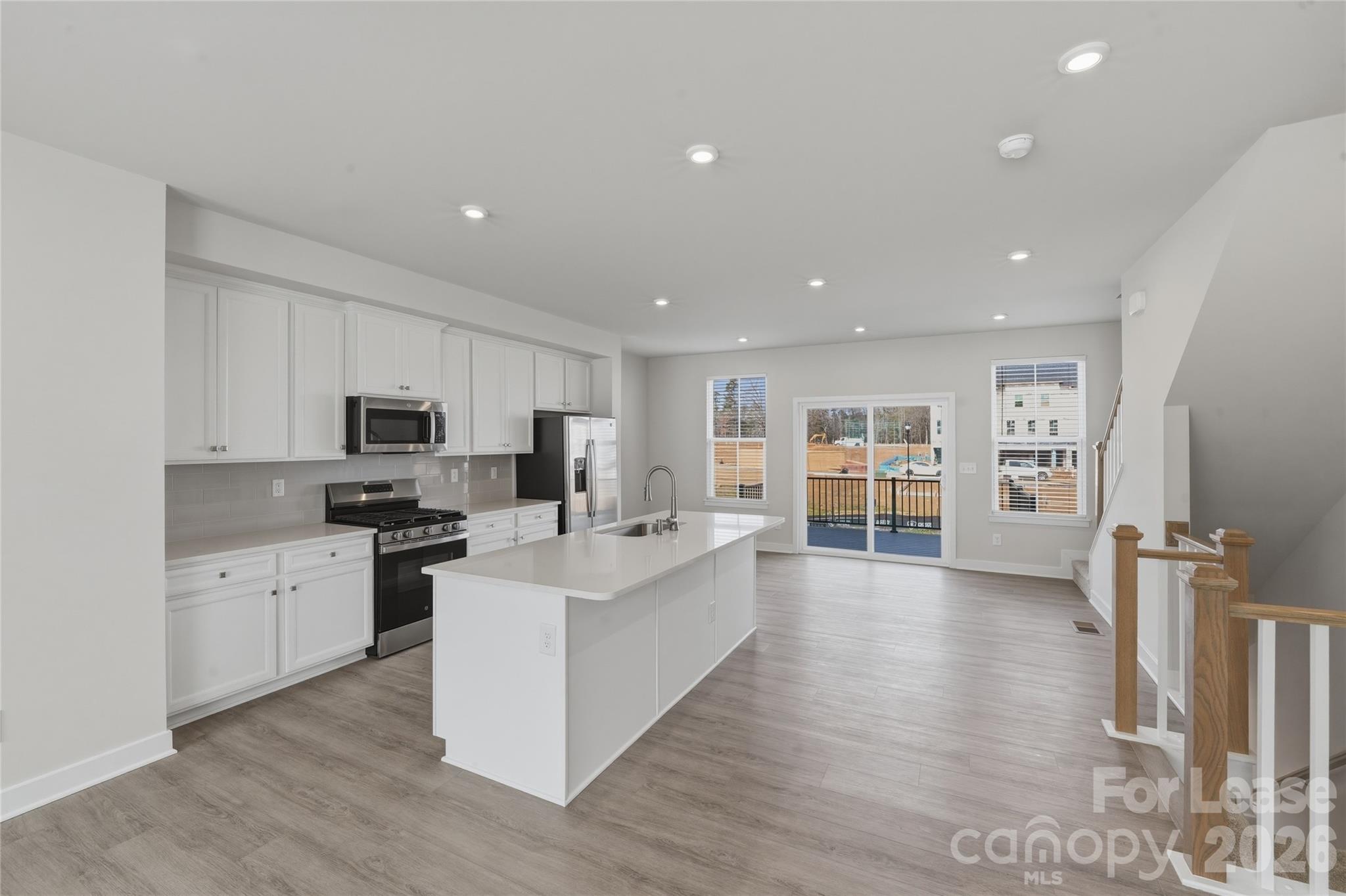 5032 Grain Orchard Road Indian Trail, NC 28079 - Photo 13 of 26 a large white kitchen with stainless steel appliances