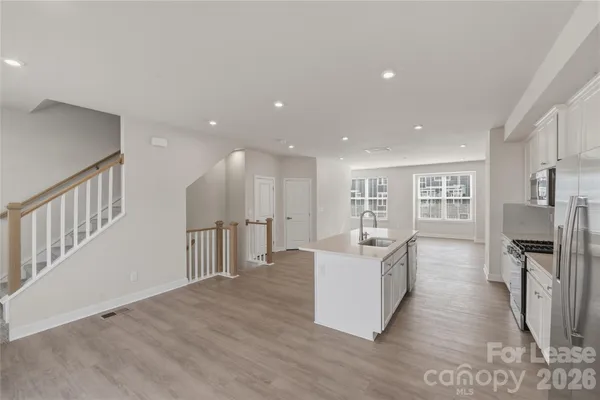 a living room with fireplace furniture and a wooden floor