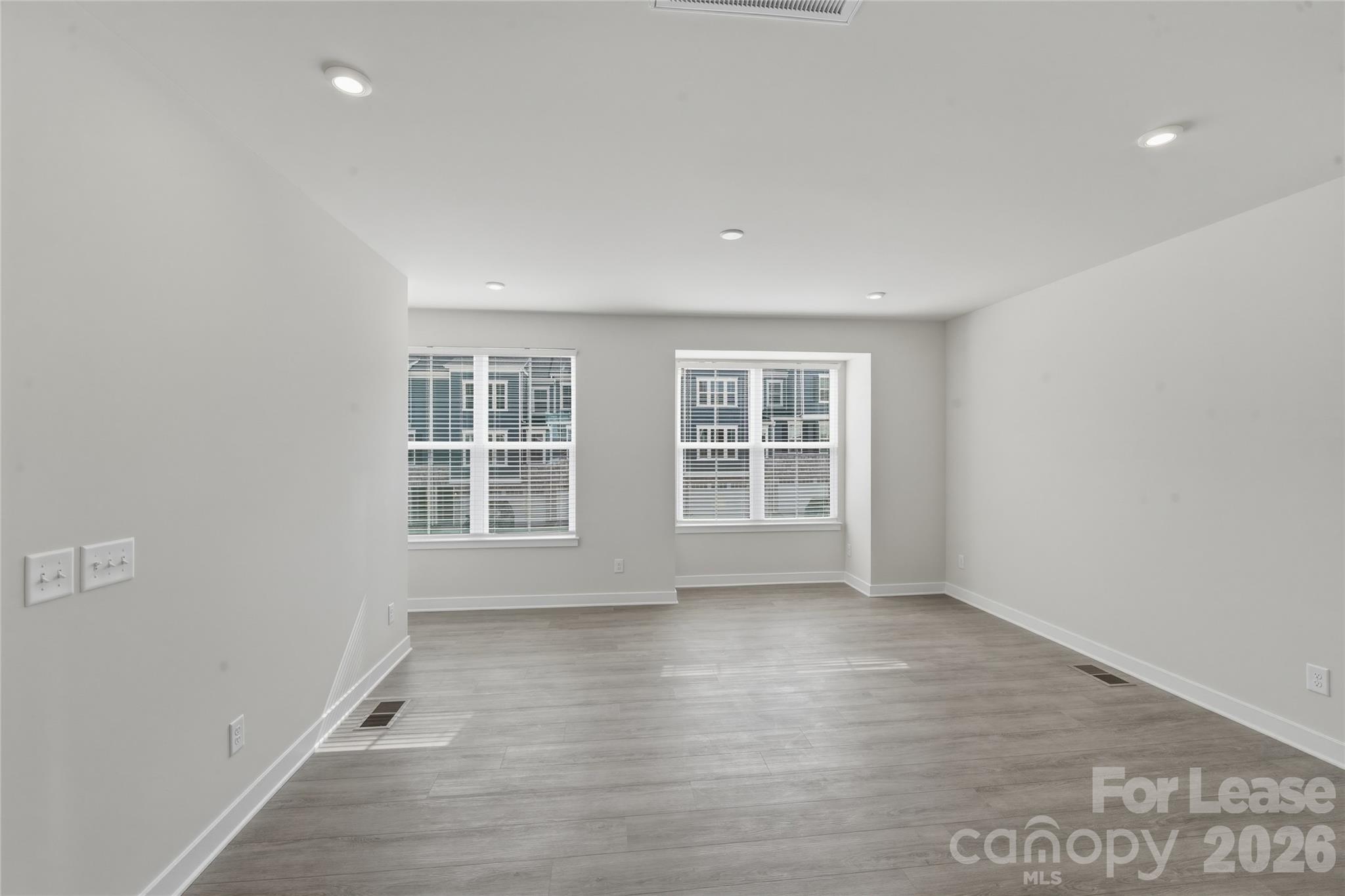 5032 Grain Orchard Road Indian Trail, NC 28079 - Photo 2 of 26 an empty room with wooden floor and windows