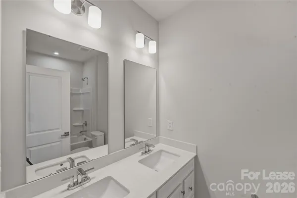 a bathroom with a sink vanity and a mirror