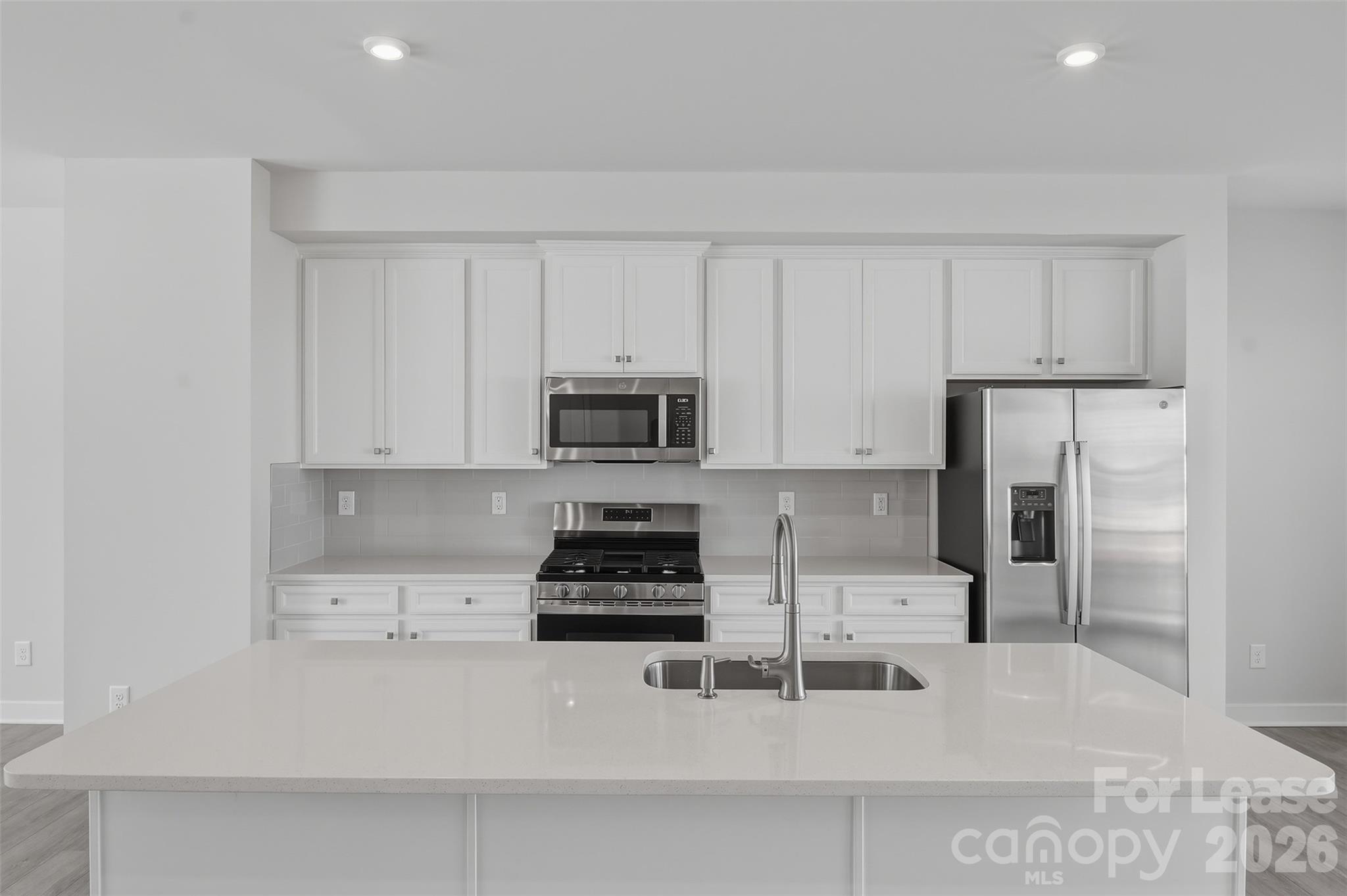 5032 Grain Orchard Road Indian Trail, NC 28079 - Photo 3 of 26 a kitchen with stainless steel appliances a stove a sink a refrigerator and cabinets