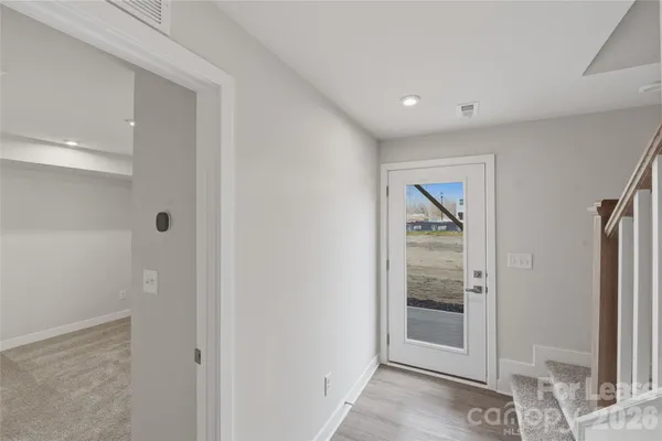 a view of a hallway with wooden shelves