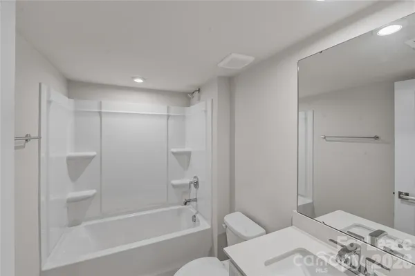 a bathroom with a bathtub and a toilet