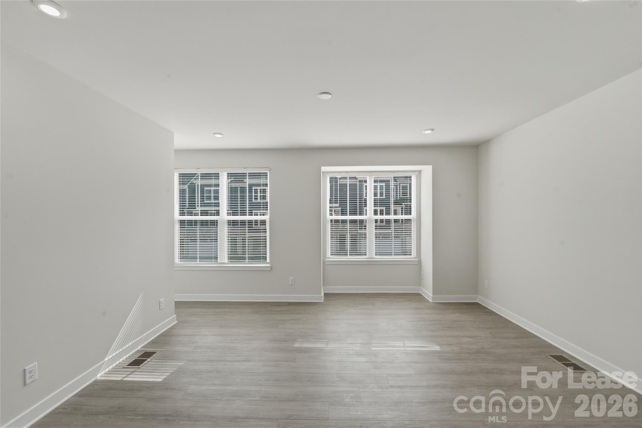 5032 Grain Orchard Road Indian Trail, NC 28079 - Photo 10 of 26 an empty room with wooden floor and windows