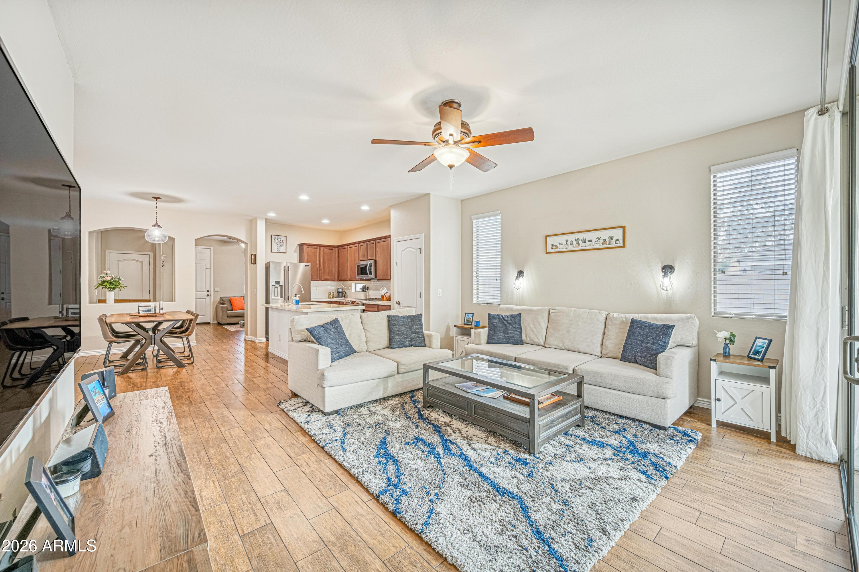 3942 South Mandarin Way Gilbert, AZ 85297 - Photo 9 of 32 a living room with furniture and a wooden floor