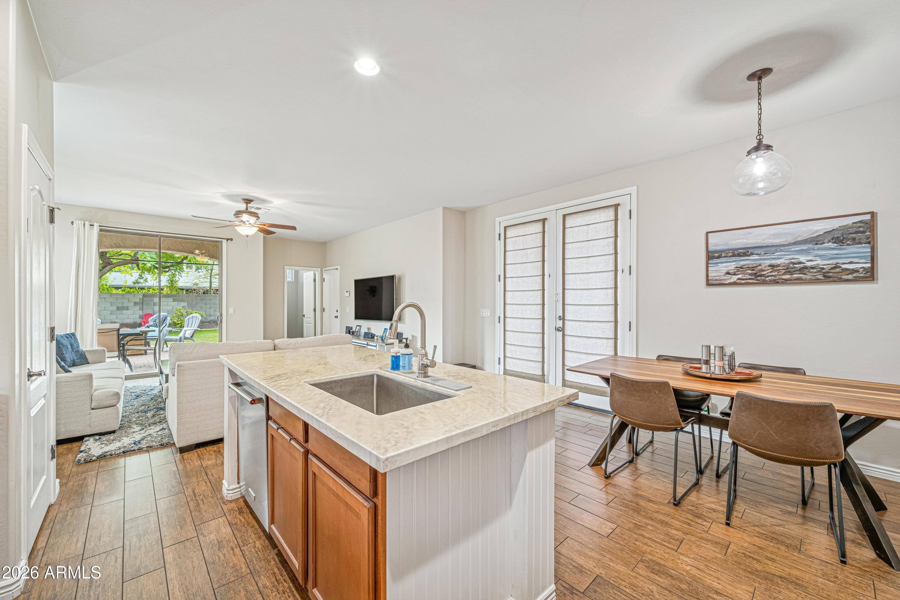 3942 South Mandarin Way Gilbert, AZ 85297 - Photo 10 of 32 a view of a dining room with furniture window and wooden floor
