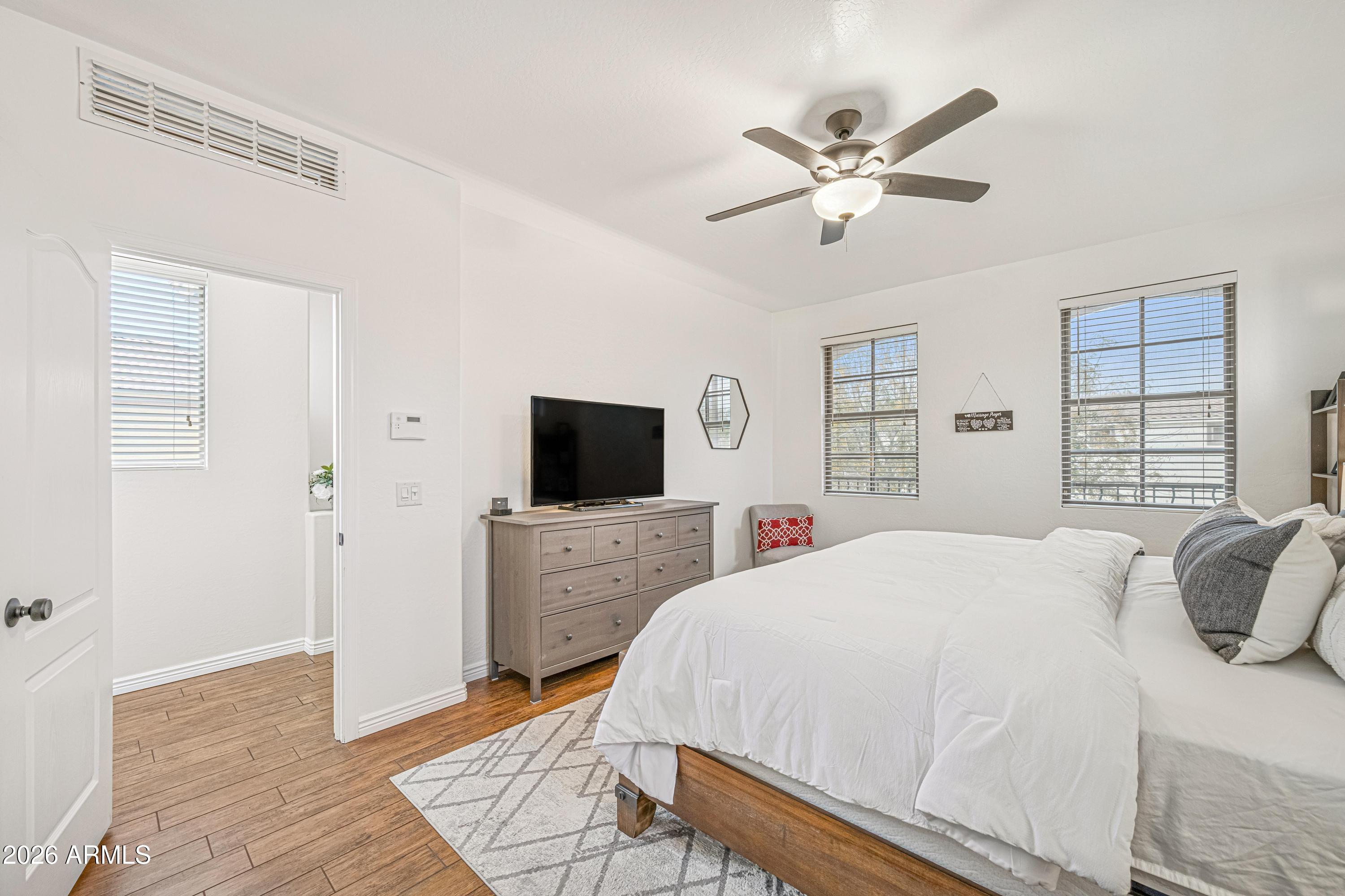 3942 South Mandarin Way Gilbert, AZ 85297 - Photo 14 of 32 a spacious bedroom with a bed and a flat screen tv