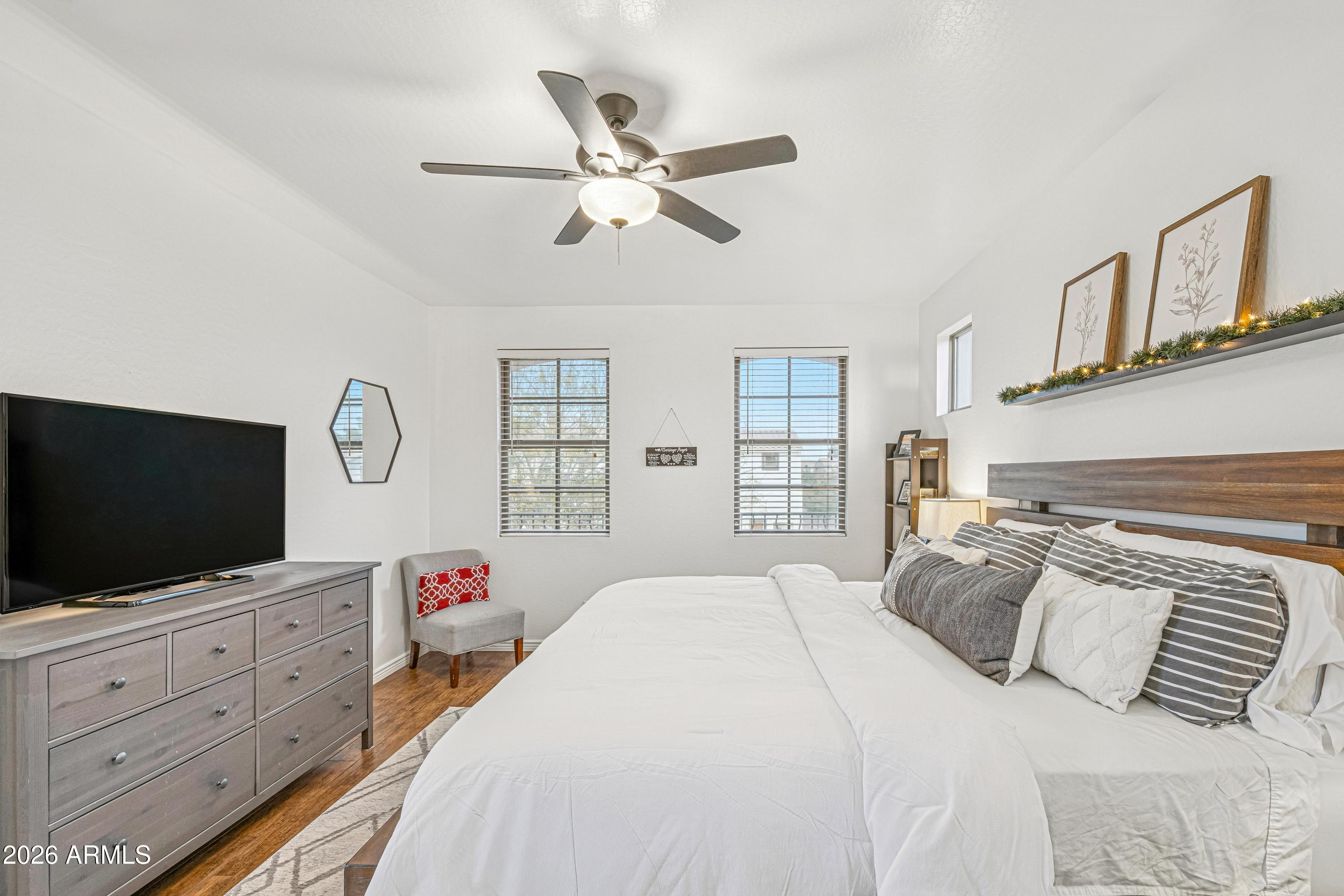 3942 South Mandarin Way Gilbert, AZ 85297 - Photo 15 of 32 a bedroom with a bed a window and a flat screen tv