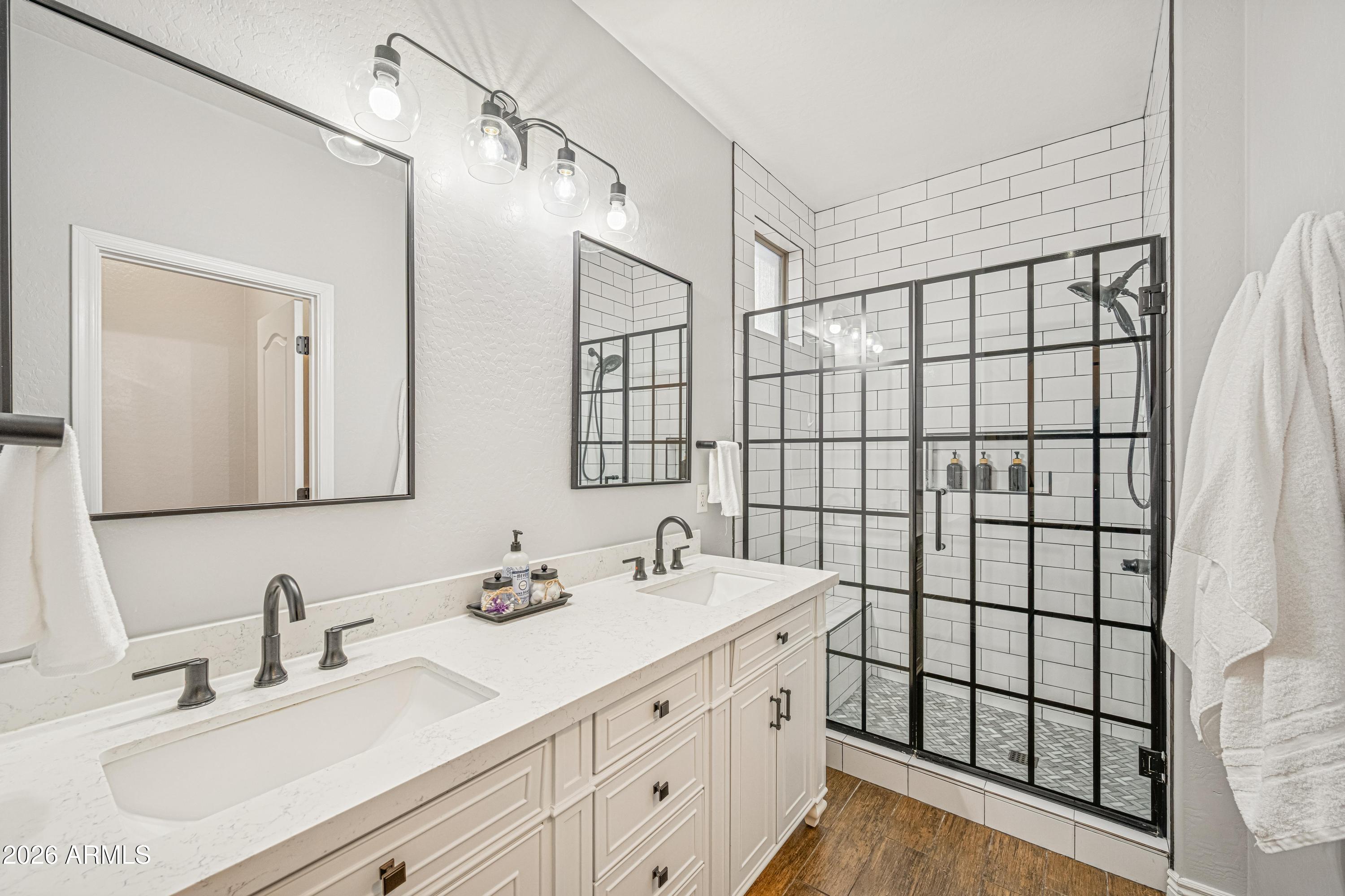 3942 South Mandarin Way Gilbert, AZ 85297 - Photo 17 of 32 a bathroom with a double vanity sink mirror and shower