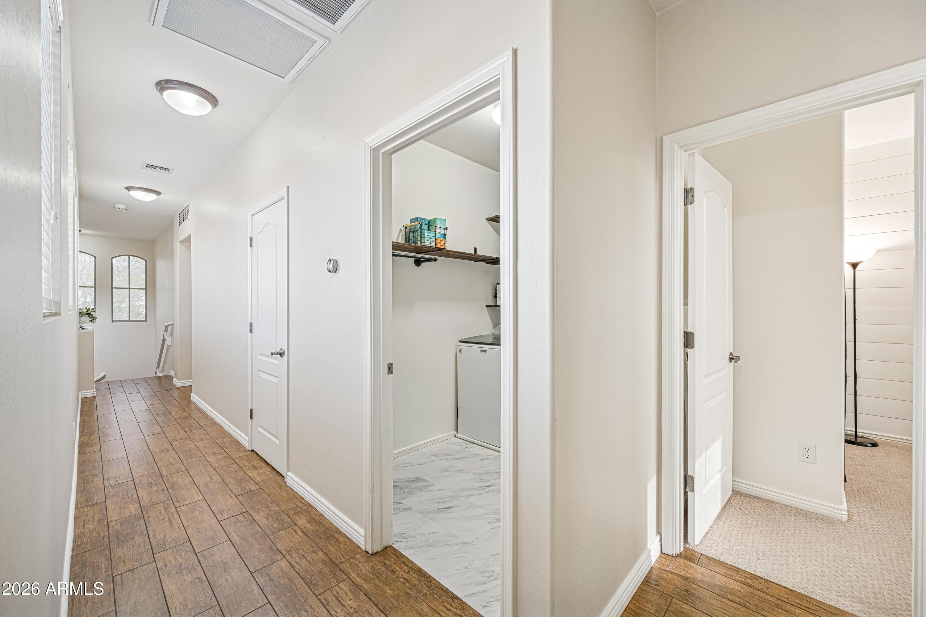 3942 South Mandarin Way Gilbert, AZ 85297 - Photo 19 of 32 a view of a hallway with wooden floor and a bathroom