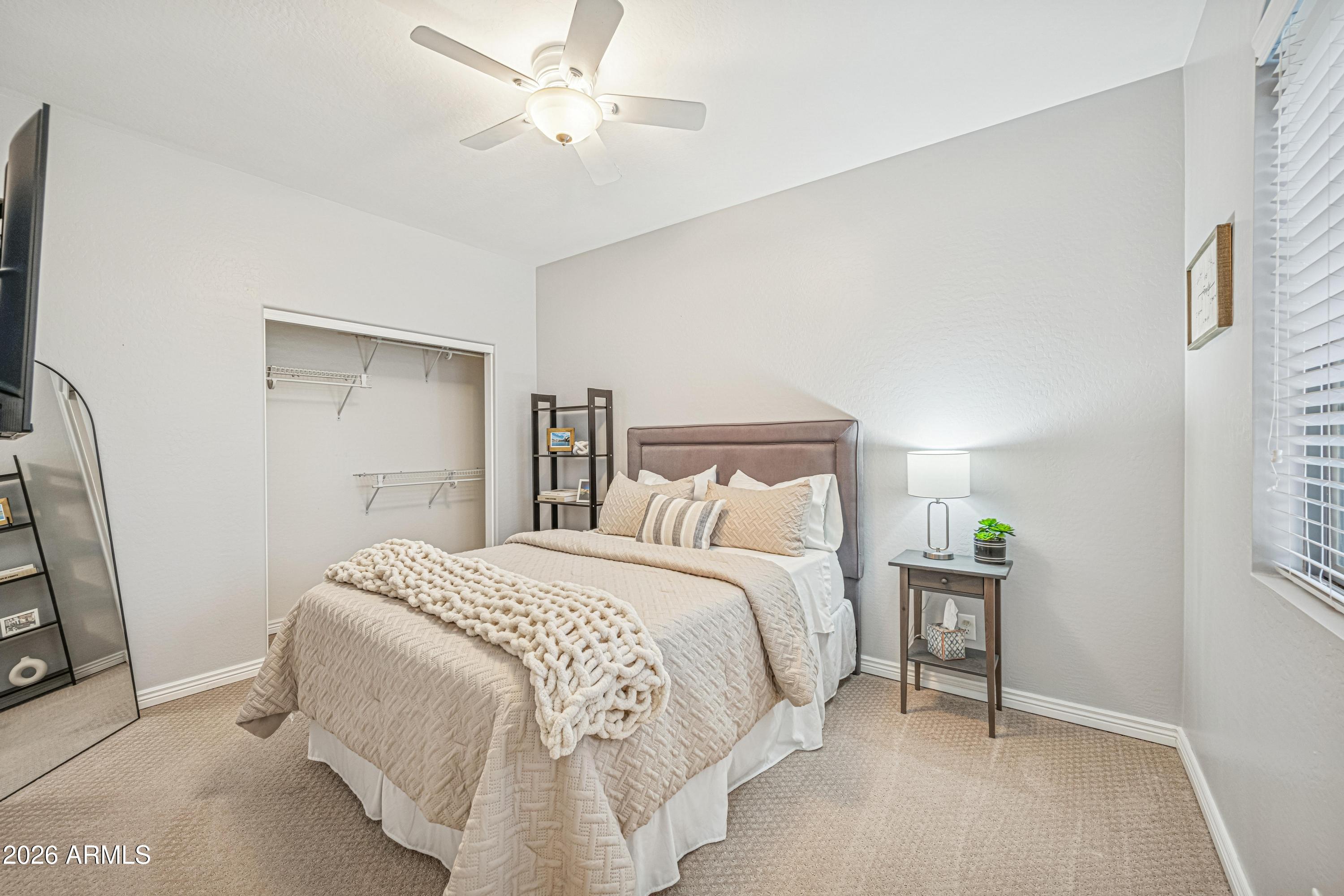3942 South Mandarin Way Gilbert, AZ 85297 - Photo 21 of 32 a bedroom with a bed and a chandelier