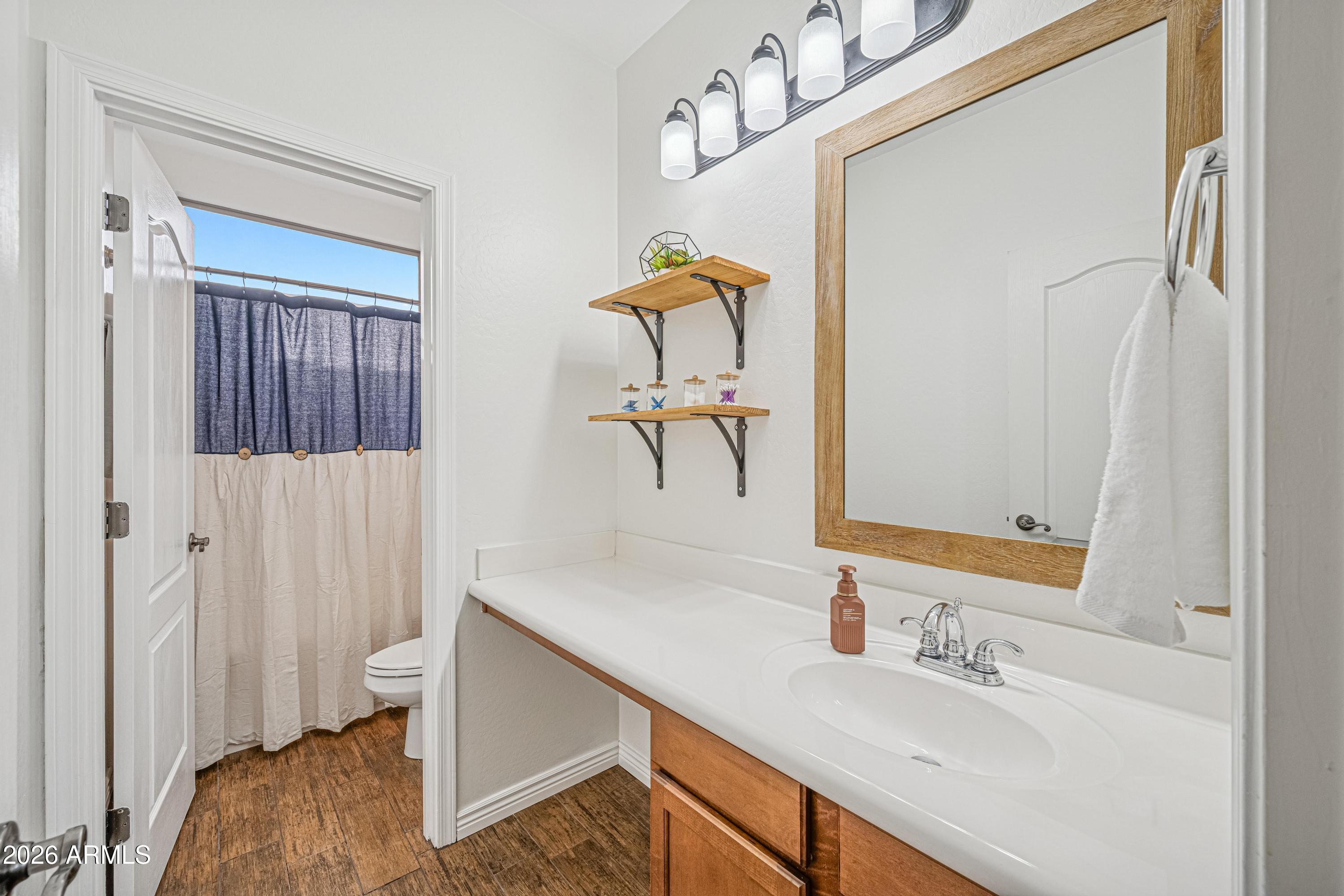 3942 South Mandarin Way Gilbert, AZ 85297 - Photo 25 of 32 a bathroom with a sink and a mirror