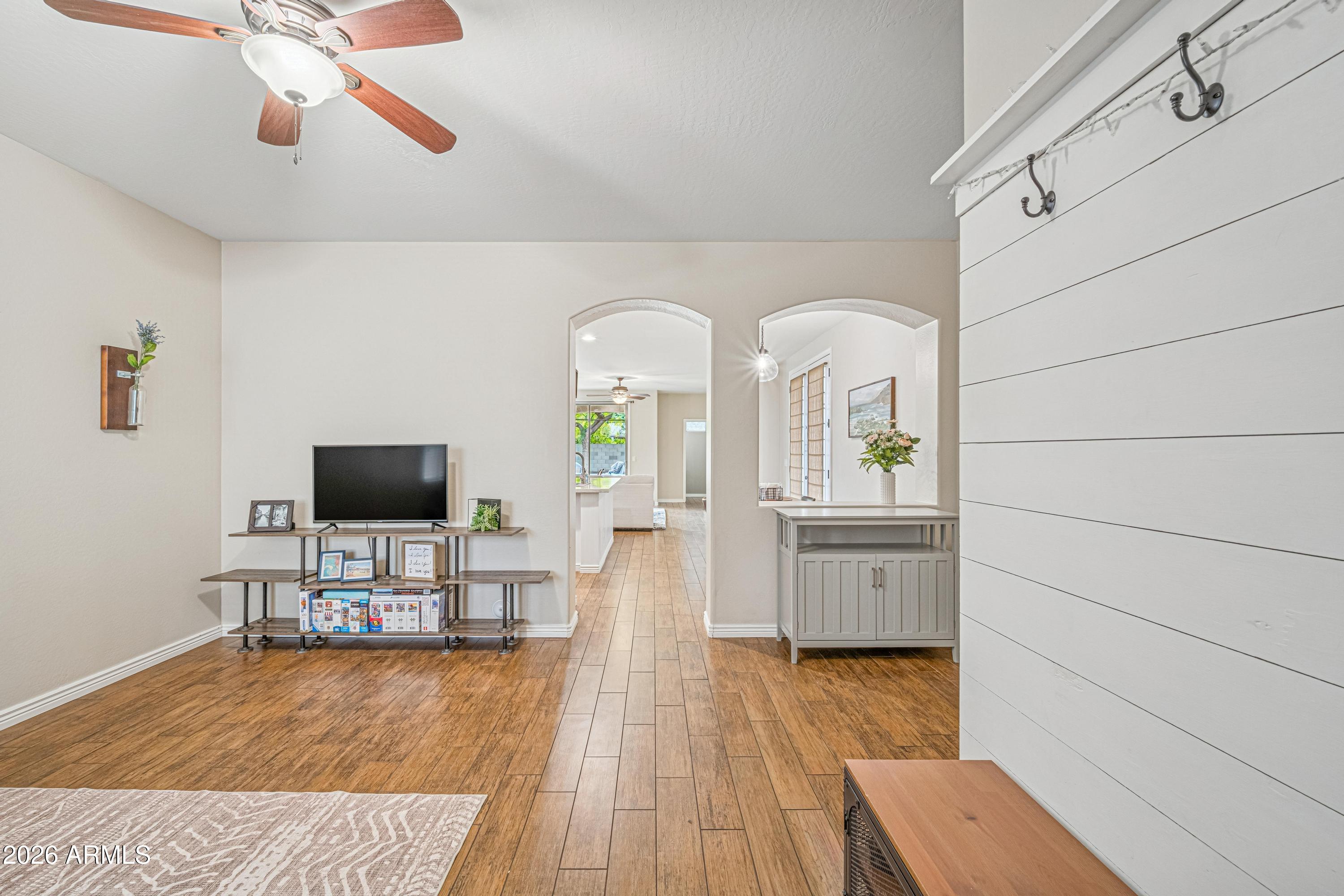3942 South Mandarin Way Gilbert, AZ 85297 - Photo 3 of 32 a living room with furniture and a flat screen tv