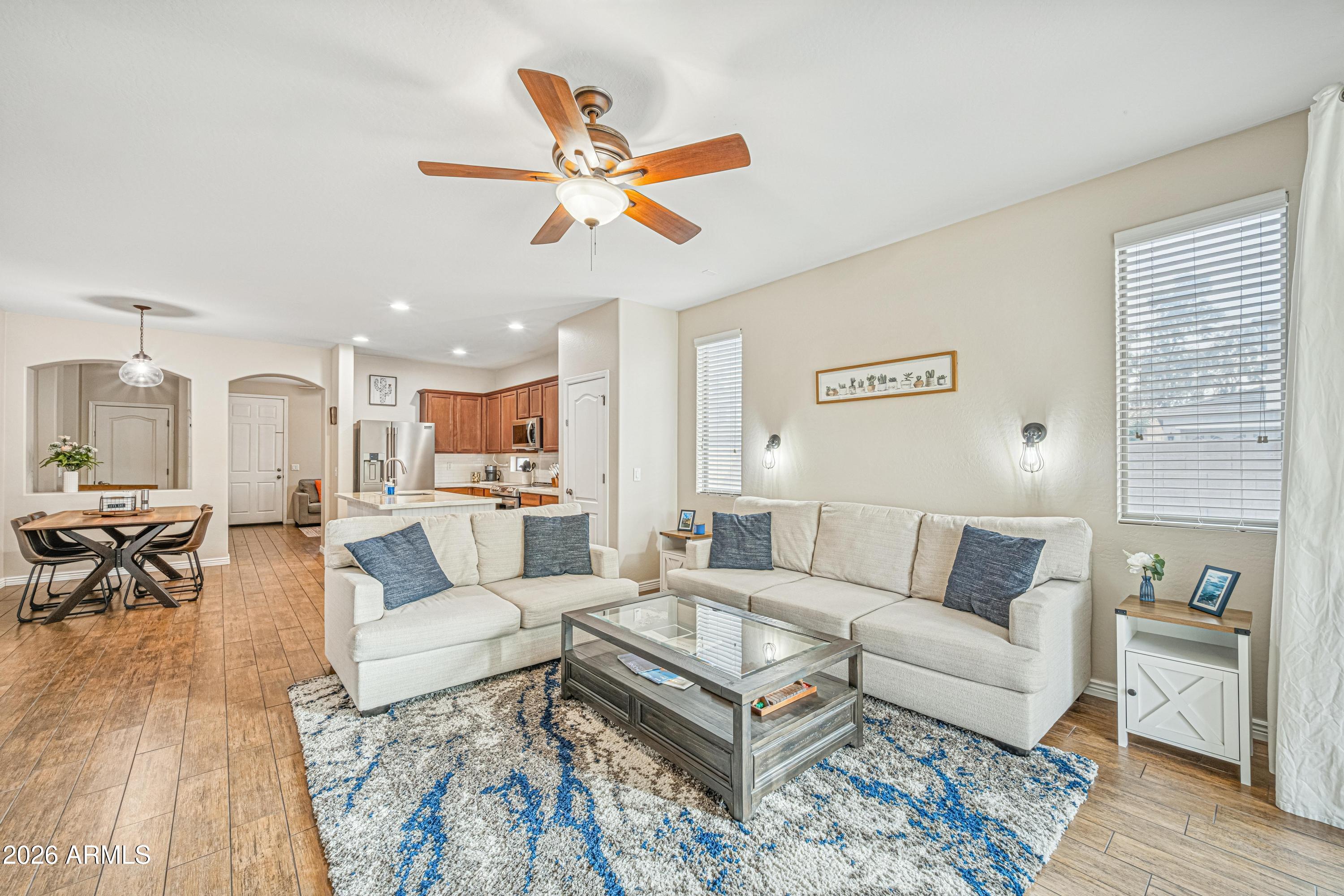 3942 South Mandarin Way Gilbert, AZ 85297 - Photo 6 of 32 a living room with furniture and a wooden floor