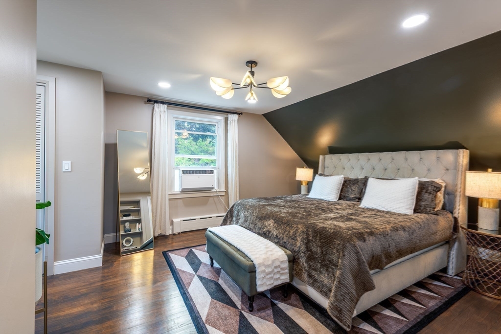 585 Station Road Amherst, MA 01002 - Photo 29 of 42 a bedroom with a large bed chandelier and a window