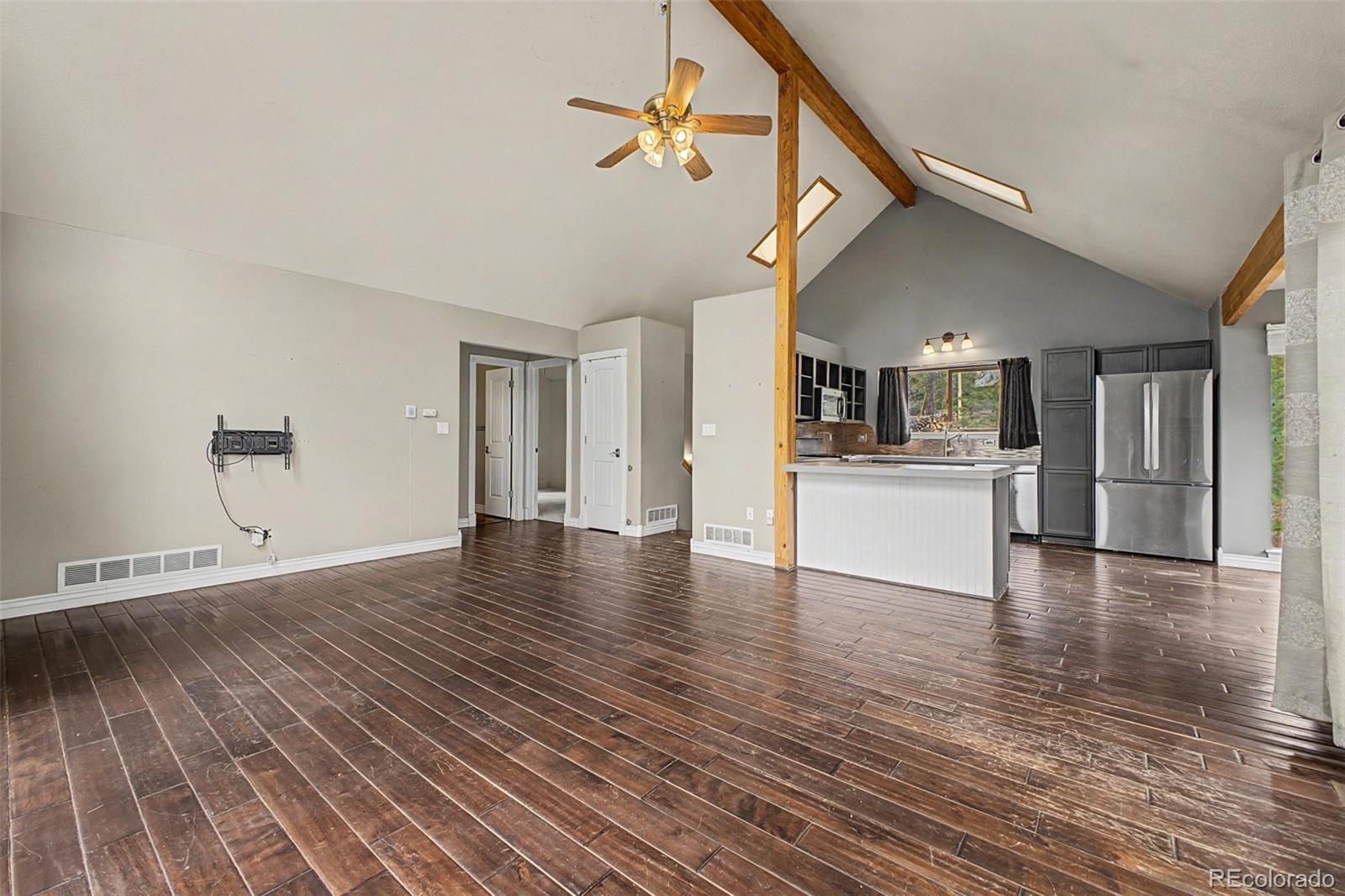 76 Highlands Drive Bailey, CO 80421 - Photo 7 of 49 a view of a kitchen with a dishwasher cabinets and wooden floor