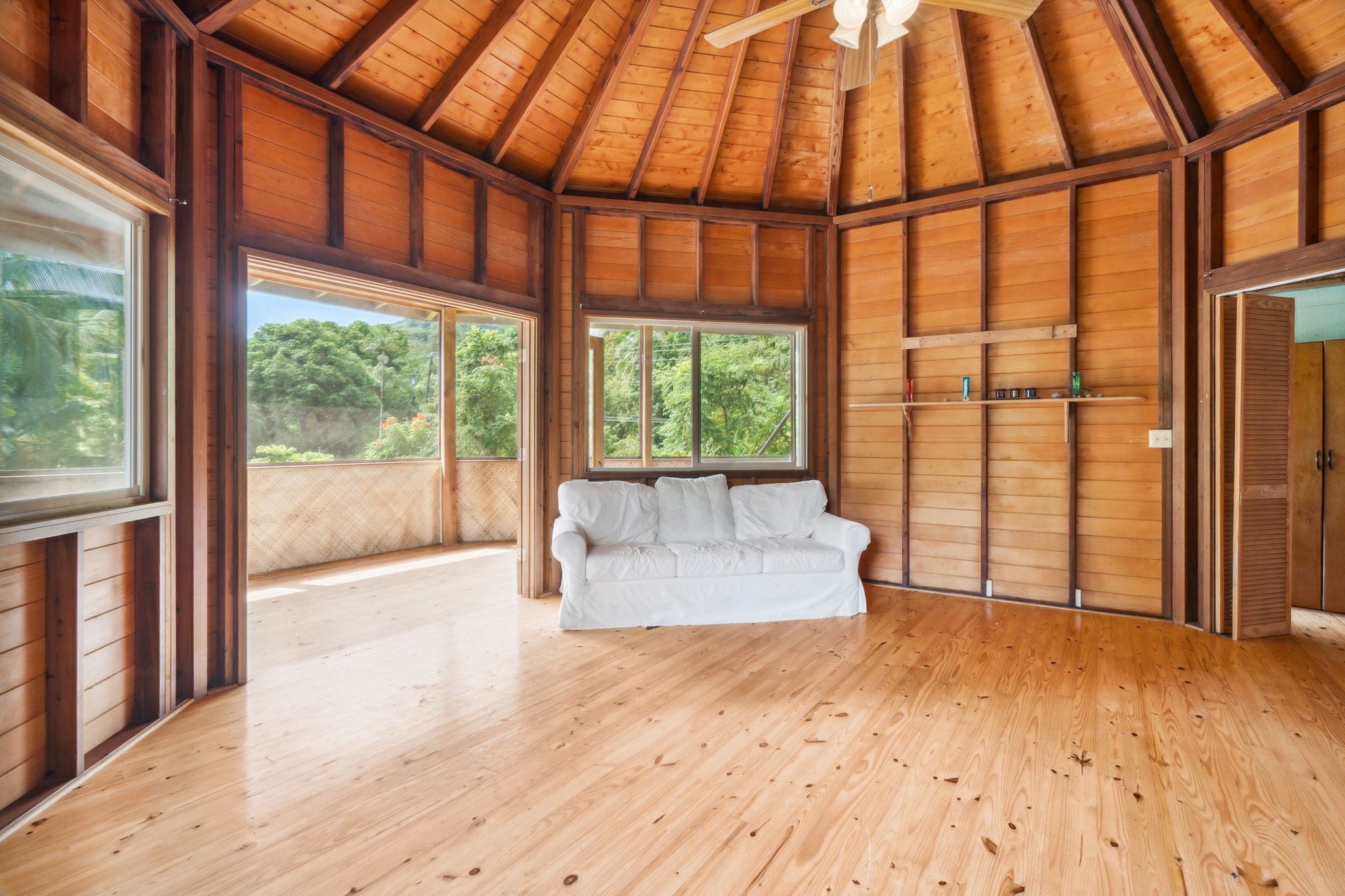 5051 Wainiha Powerhouse Road Hanalei, HI 96714 - Photo 12 of 28 a view of an empty room with wooden floor and a window