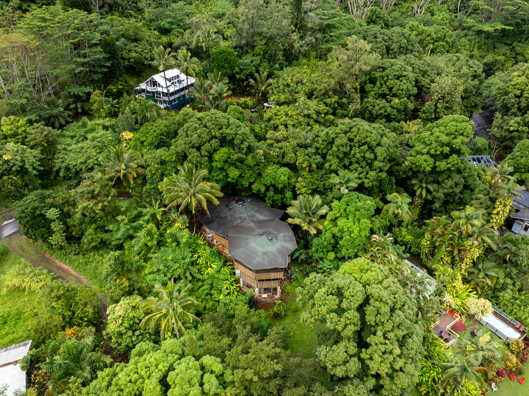 5051 Wainiha Powerhouse Road Hanalei, HI 96714 - Photo 21 of 28 a backyard of a house with a yard and seating area