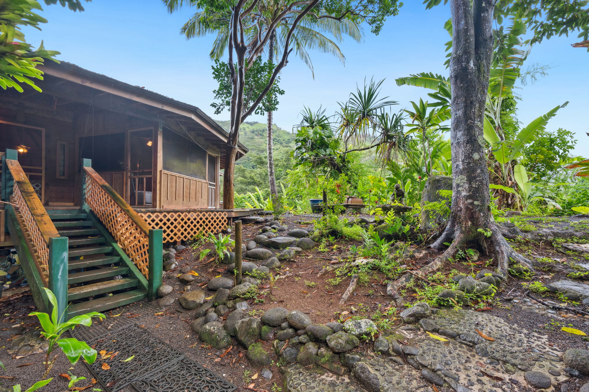 5051 Wainiha Powerhouse Road Hanalei, HI 96714 - Photo 3 of 28 a view of a backyard with a deck