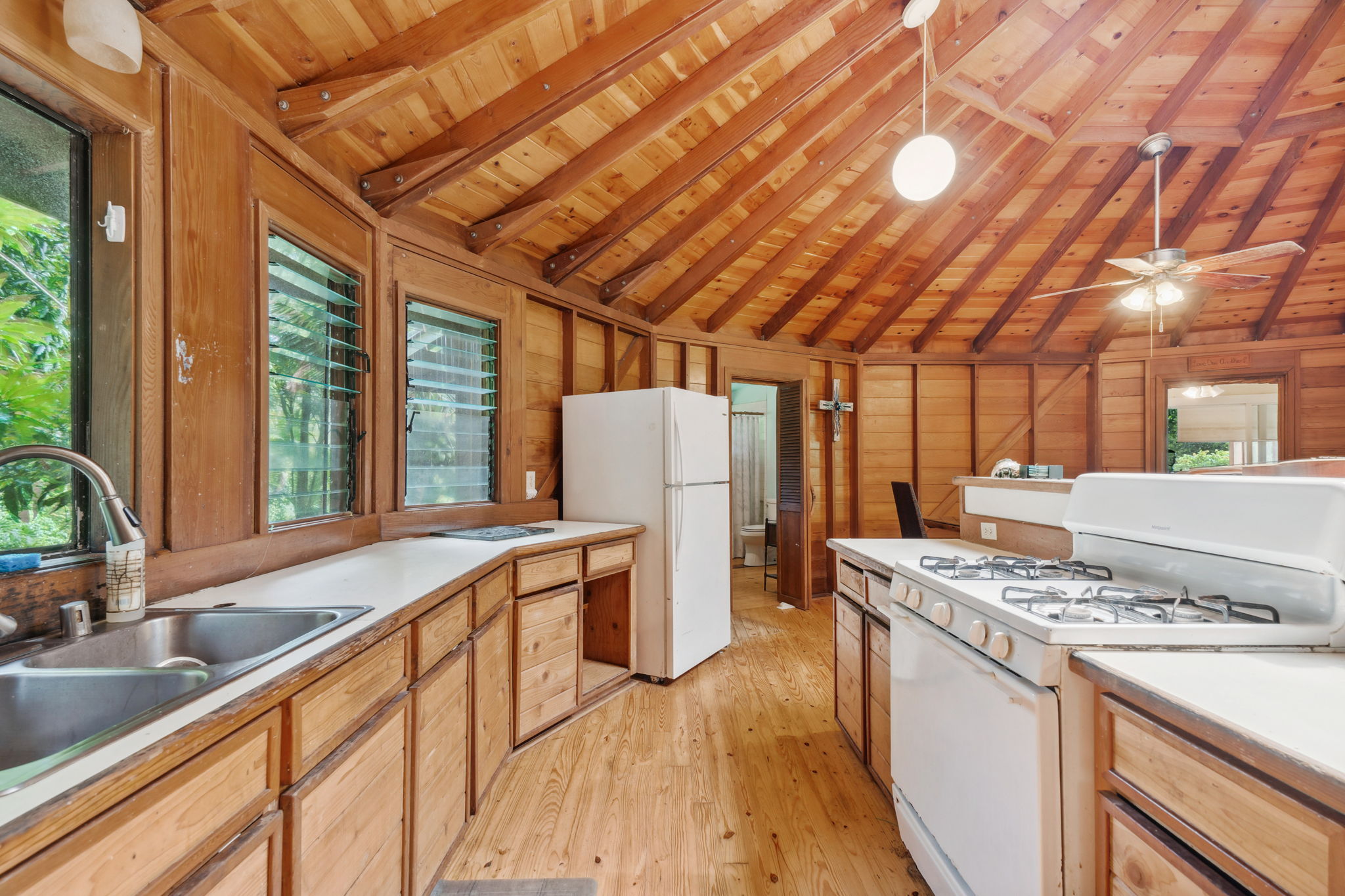 5051 Wainiha Powerhouse Road Hanalei, HI 96714 - Photo 6 of 28 a kitchen that has a sink and a stove top oven