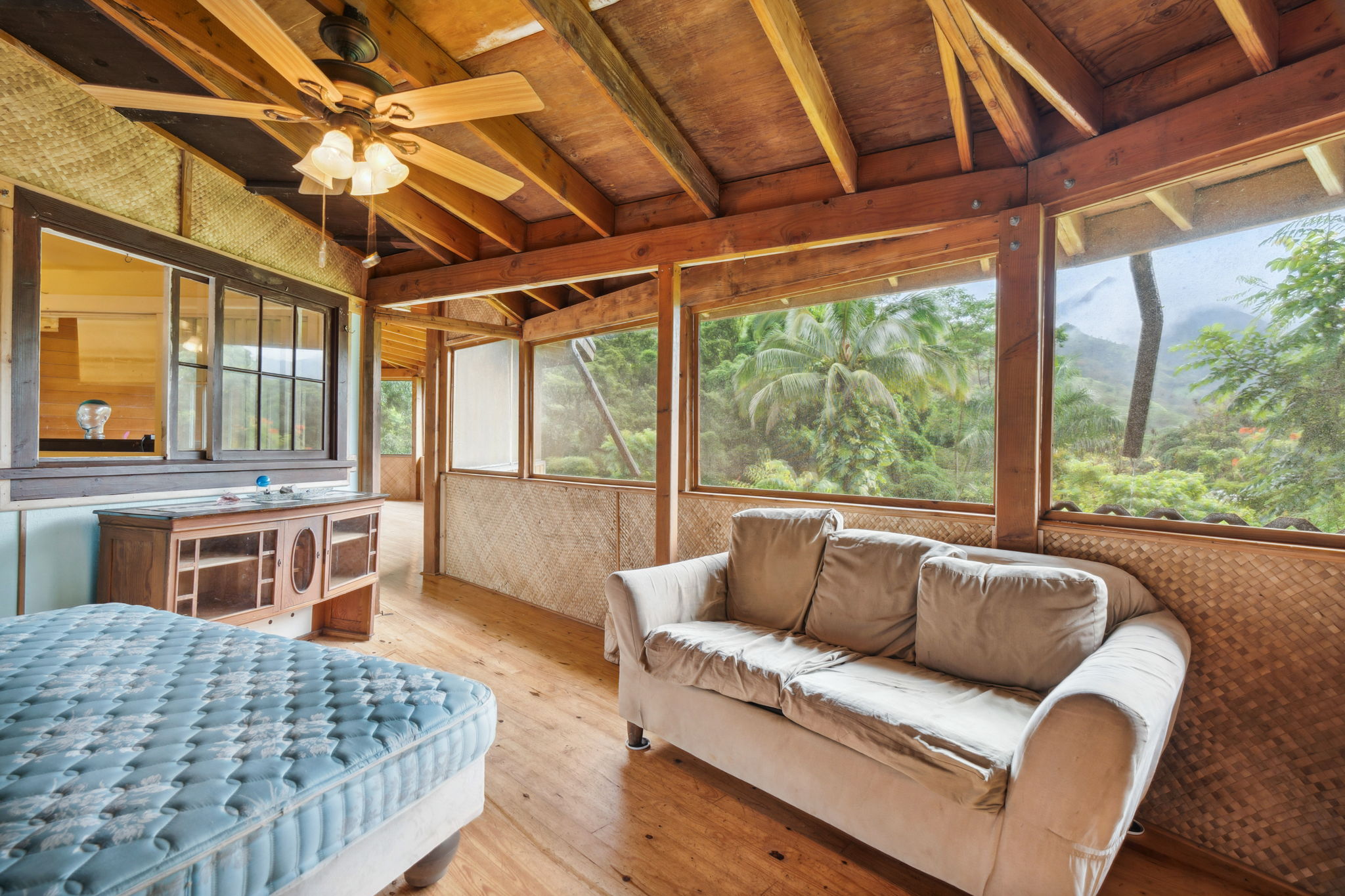 5051 Wainiha Powerhouse Road Hanalei, HI 96714 - Photo 7 of 28 a living room with furniture a large window with kitchen view