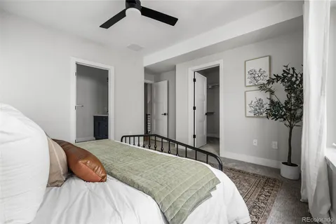 a bedroom with a large bed and a chandelier