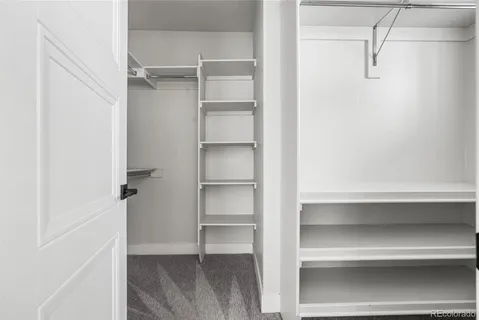 a view of walk in closet with empty racks