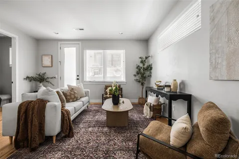 a living room with furniture flowerpot and a window