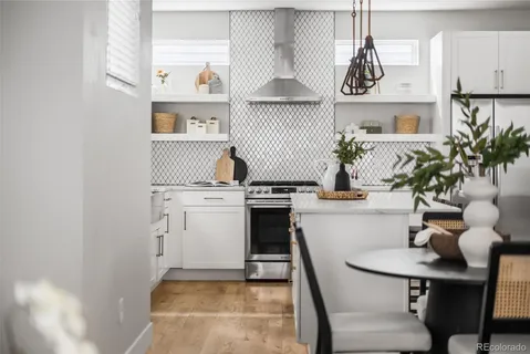 a kitchen with cabinets and chairs