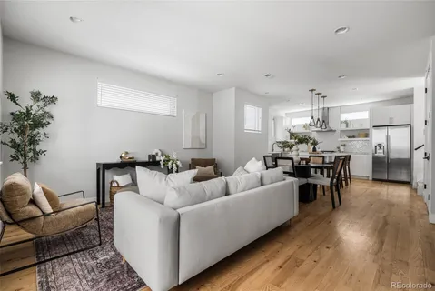 a living room with furniture and kitchen view