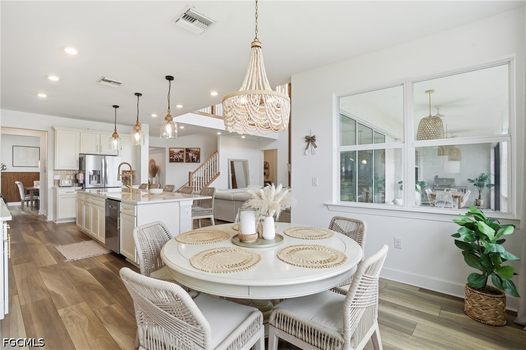 15572 Northridge Road Punta Gorda, FL 33982 - Photo 14 of 48 a dining room with furniture a chandelier and wooden floor
