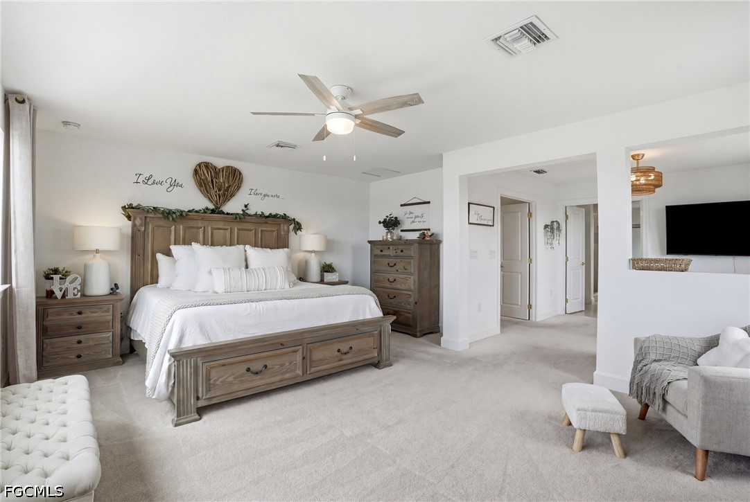 15572 Northridge Road Punta Gorda, FL 33982 - Photo 26 of 48 a spacious bedroom with a bed and flat screen tv